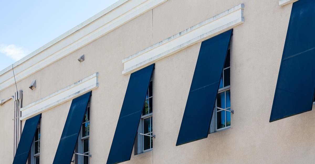 blue storm shutters on stucco building