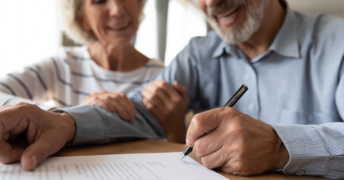 old mature couple spouses put signature on document