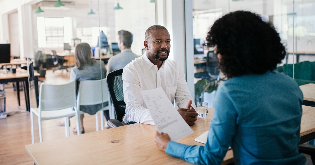 smiling job applicant answering questions during an office interview