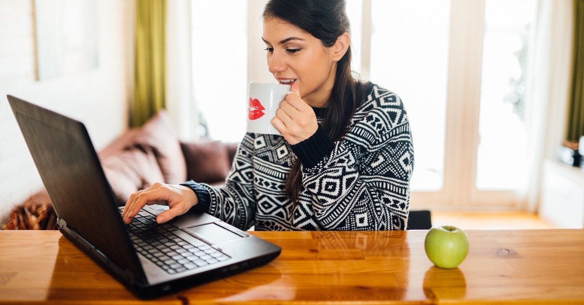 entrepreneur checking email while drinking coffee