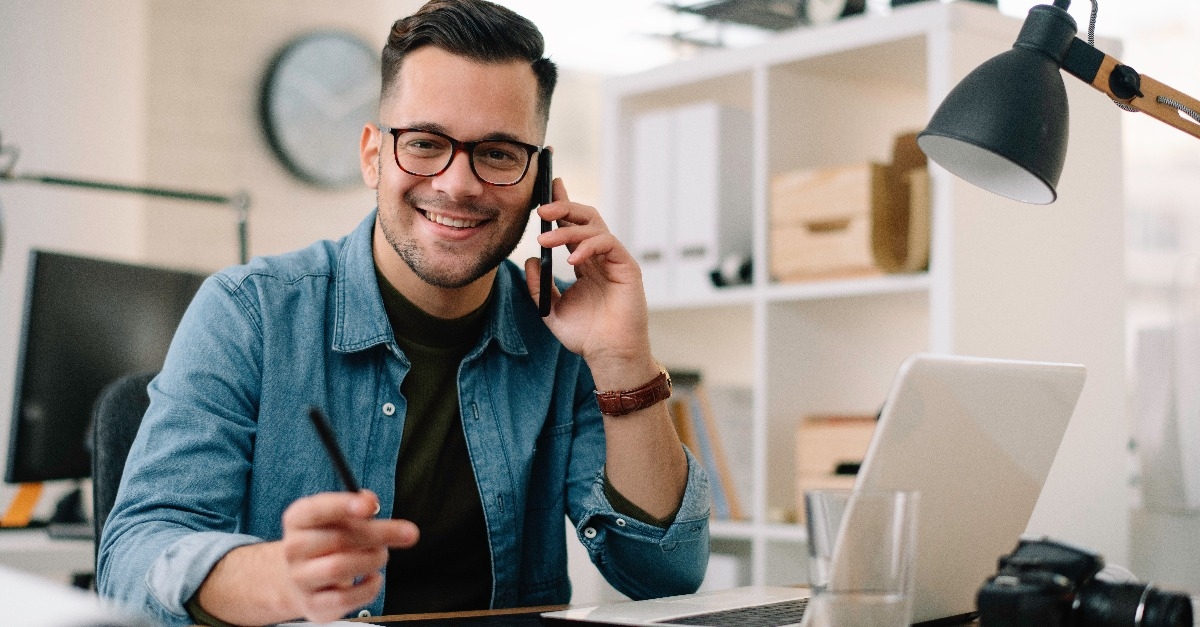 man talking on phone at work