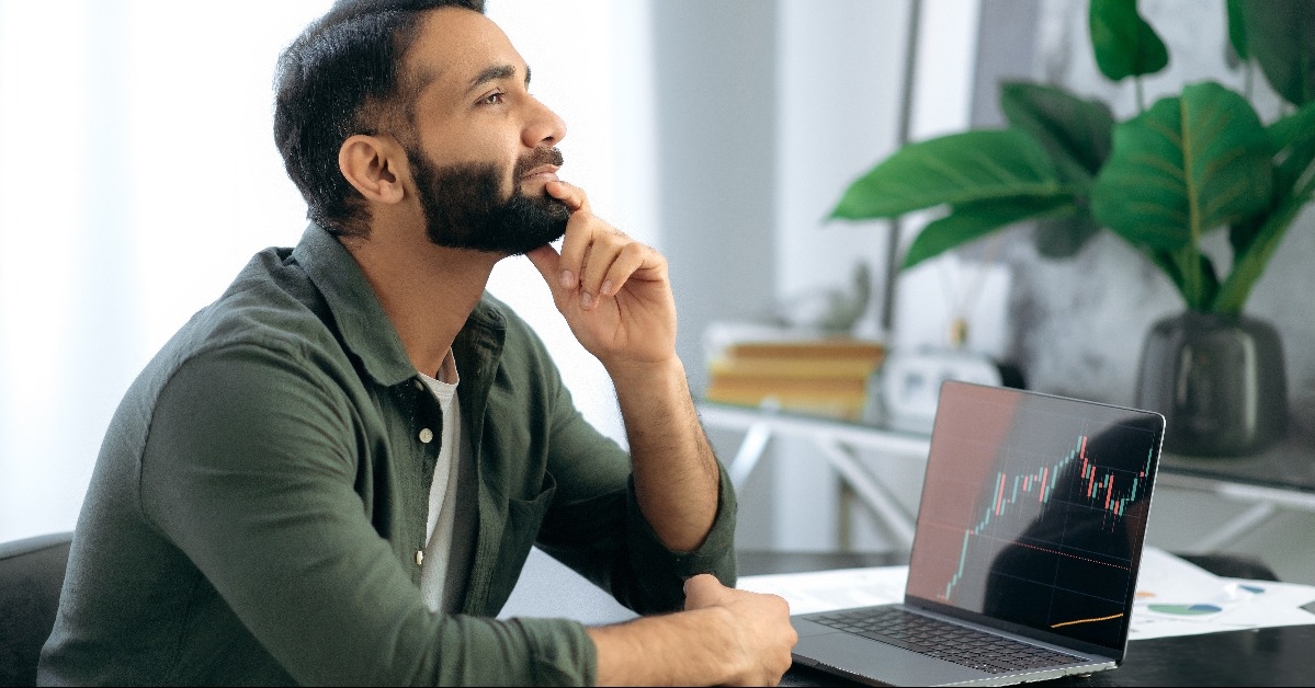 male crypto trader thoughtfully looks ahead