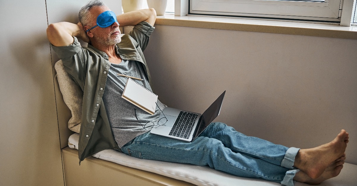 man giving eyes a break from working on laptop