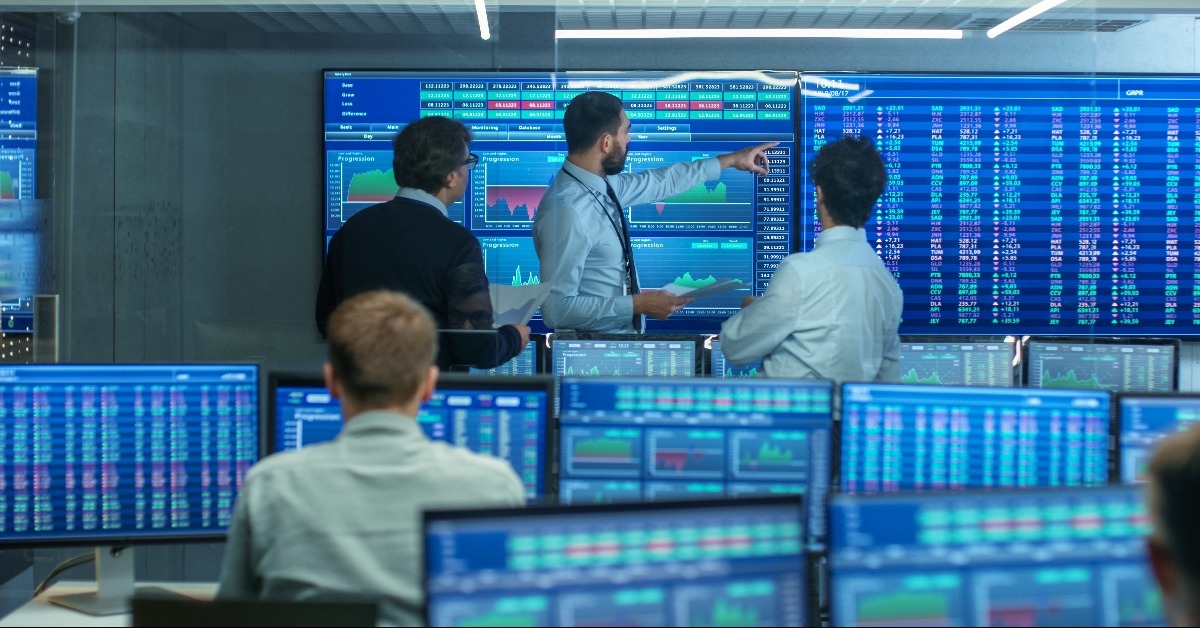 three experienced stock traders talking business