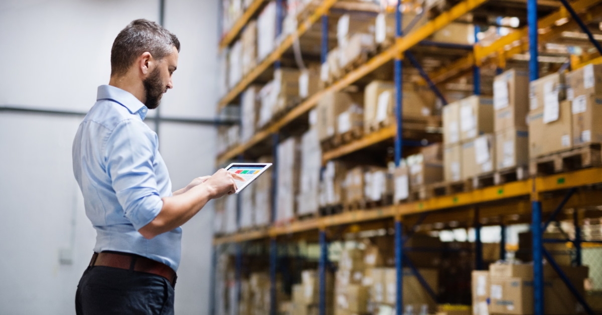 manager in warehouse using tablet