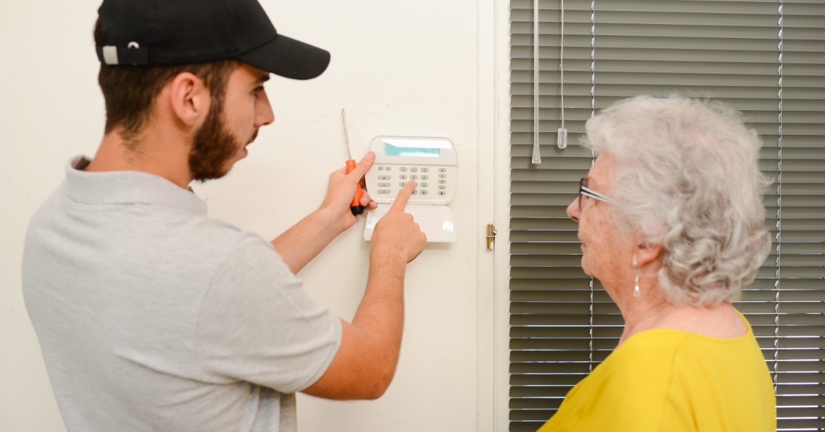 young man installing anti burglary system at home