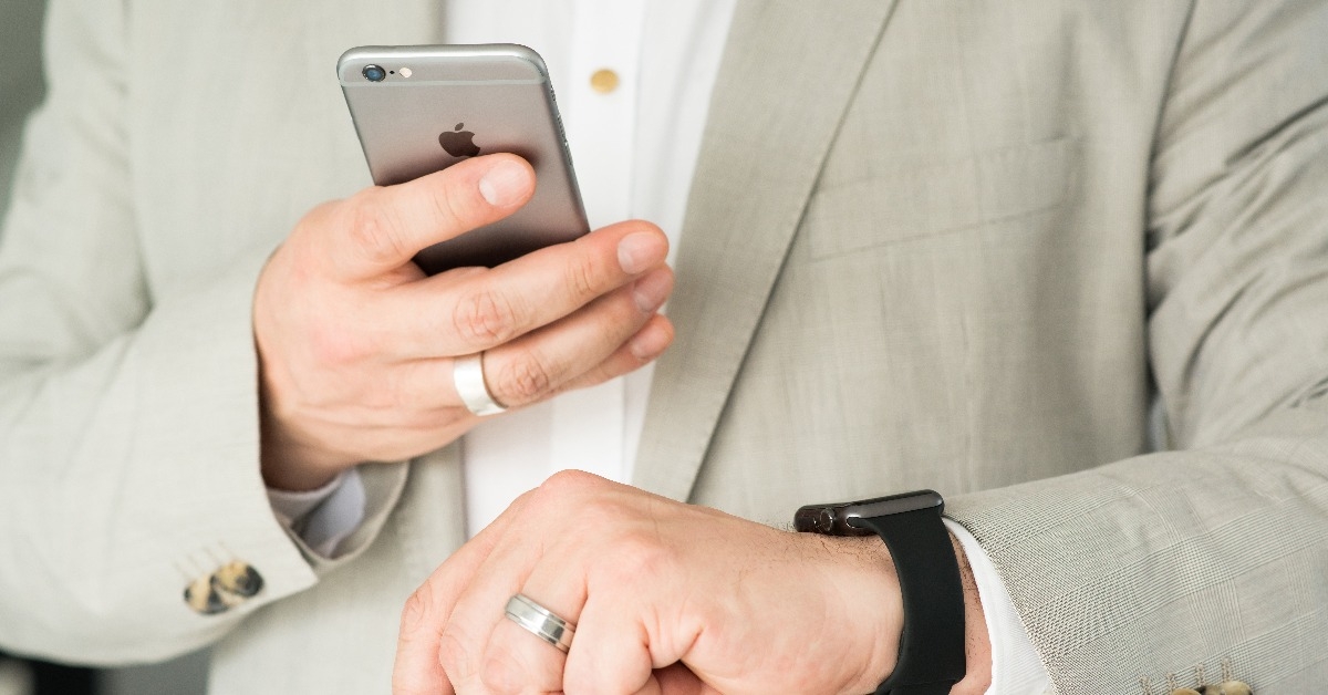 businessman using the Apple Watch and an Apple iPhone 6