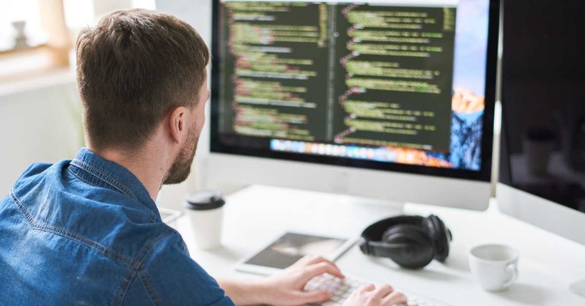 contemporary web developer writing code for program