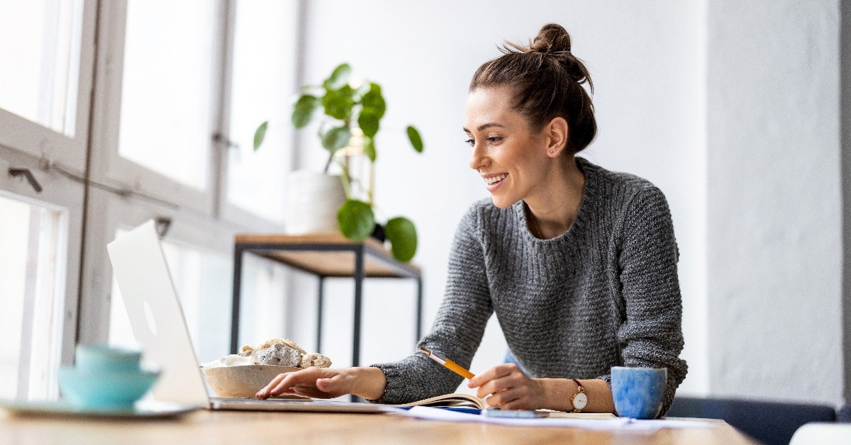  young woman working on laptop in her studio