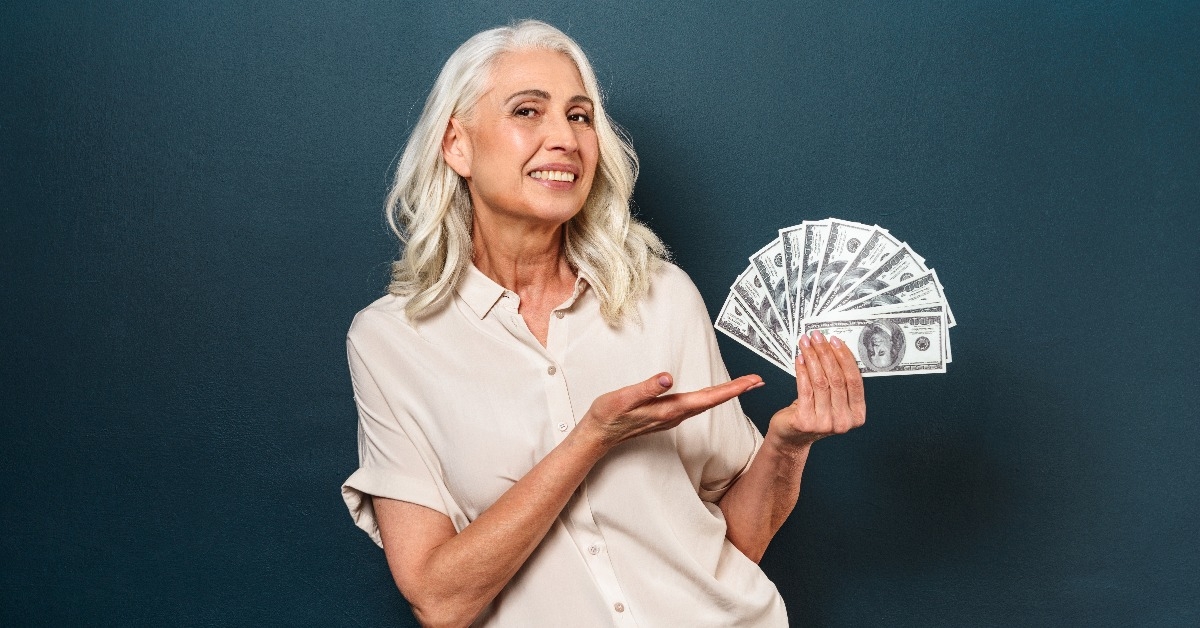 mature old woman showing money holding in hands