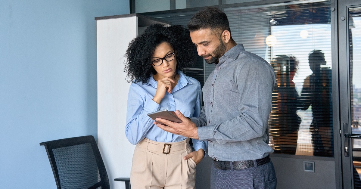 financial managers working on investment operations using tablet device