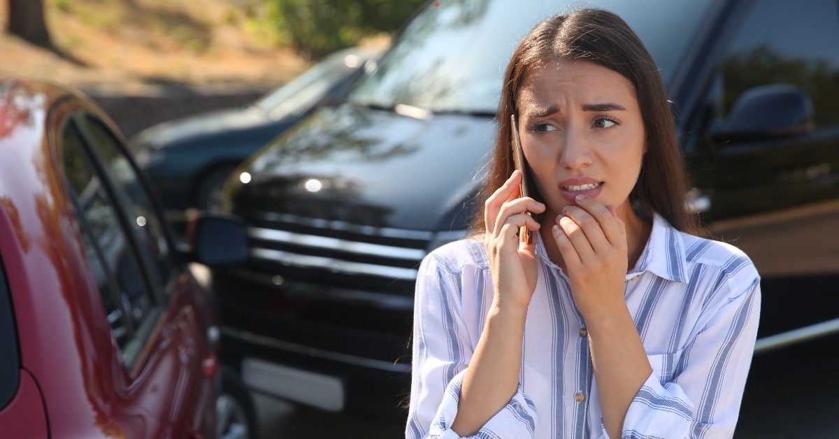 stressed woman talking on phone after car accident