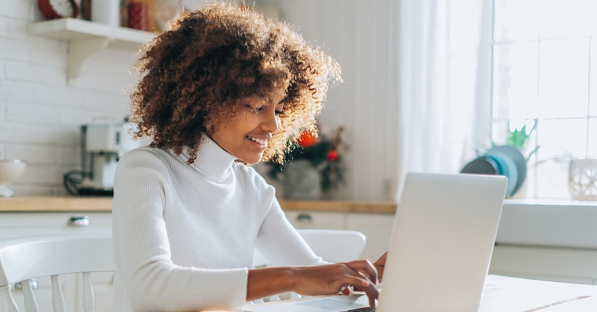 young buyer with trendy hair looks in laptop 