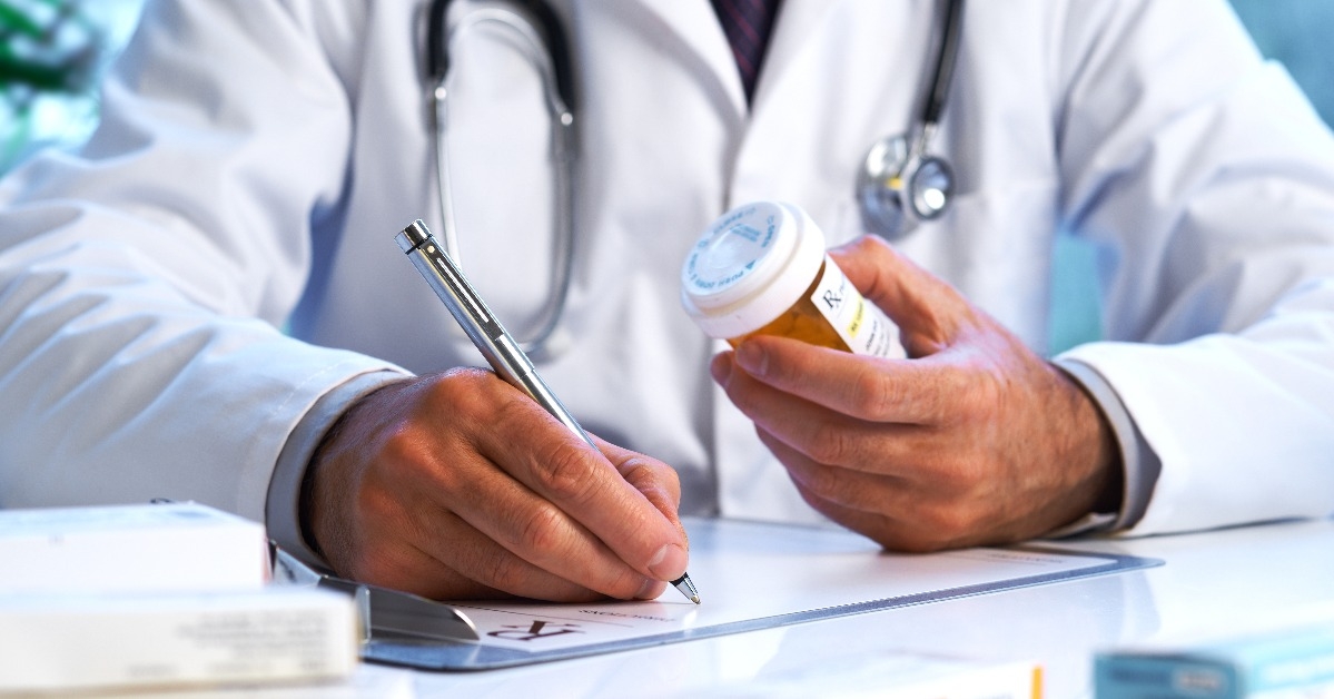 doctor writing out RX prescription