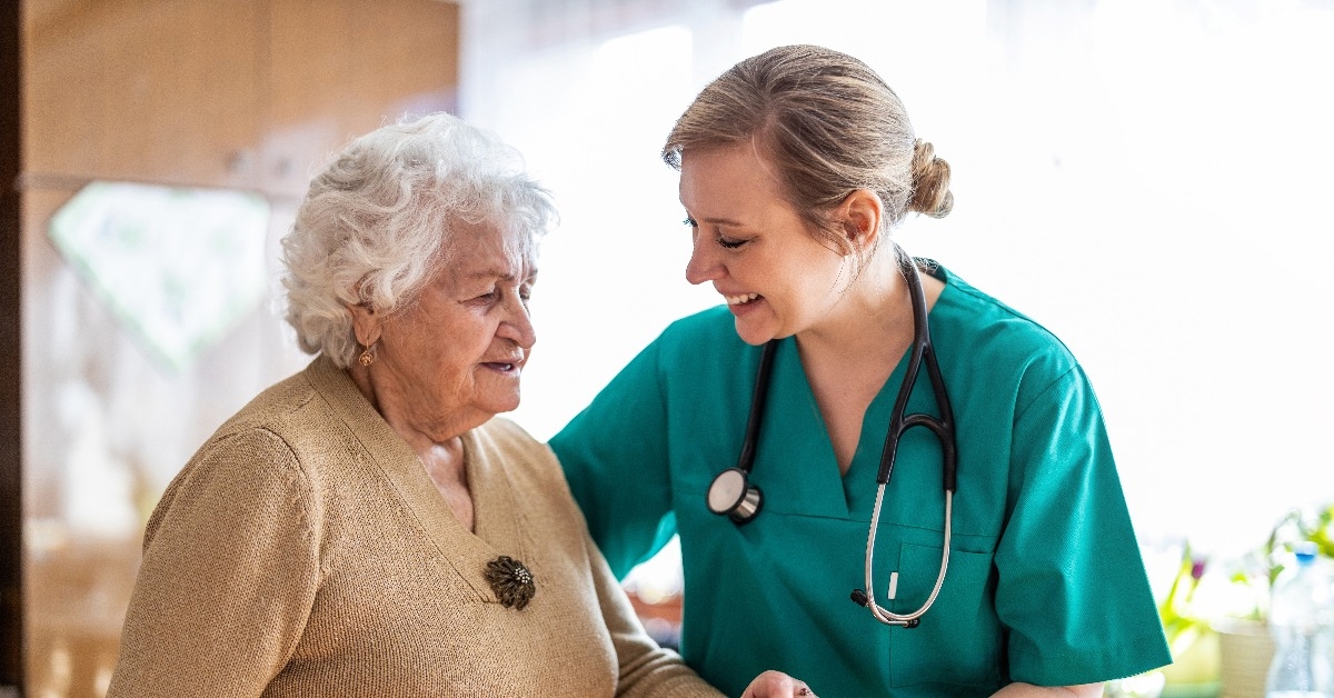friendly nurse supporting an elderly lady