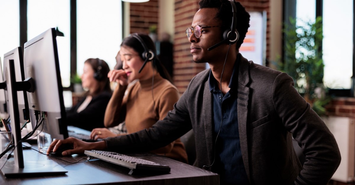 employees in an office wearing headphones