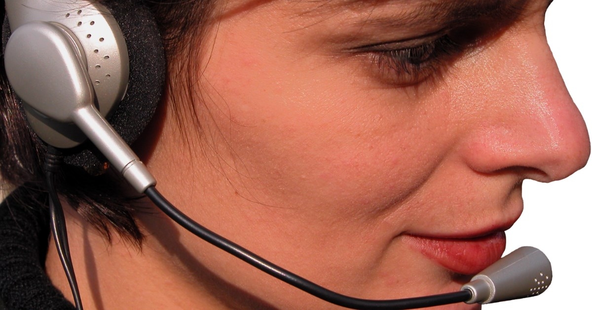salesperson smiling using headphones