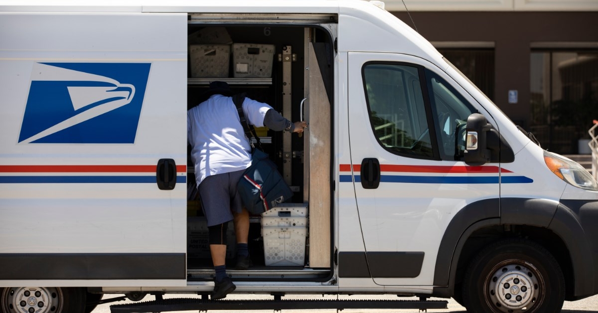 usps worker getting inside the van