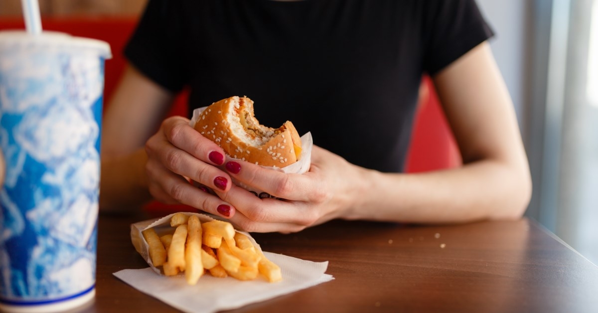 woman holding a burger 