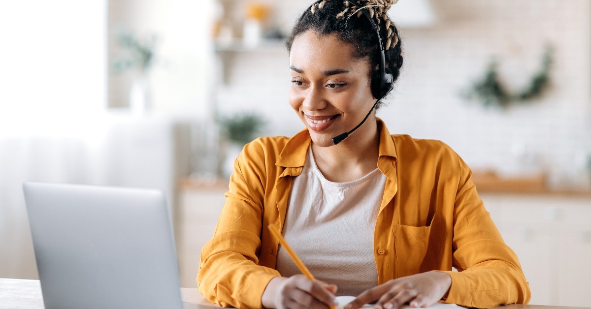 female student learning at home using a laptop