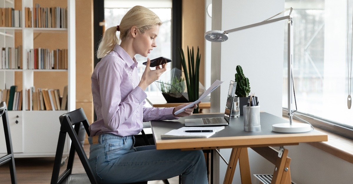 entrepreneur giving command to virtual assistant on cellphone