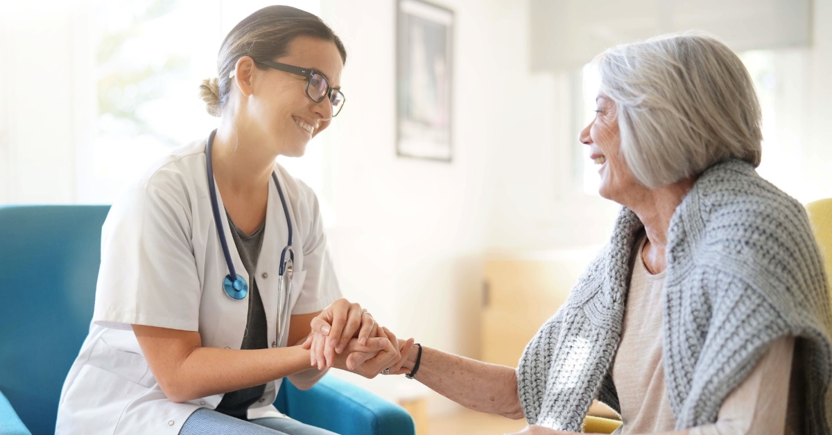 doctor reassuring an elderly women in clinic