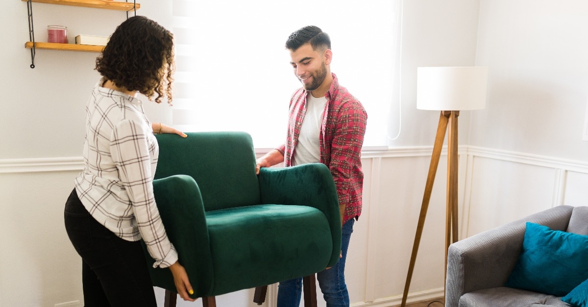 couple moving furniture and doing home improvements