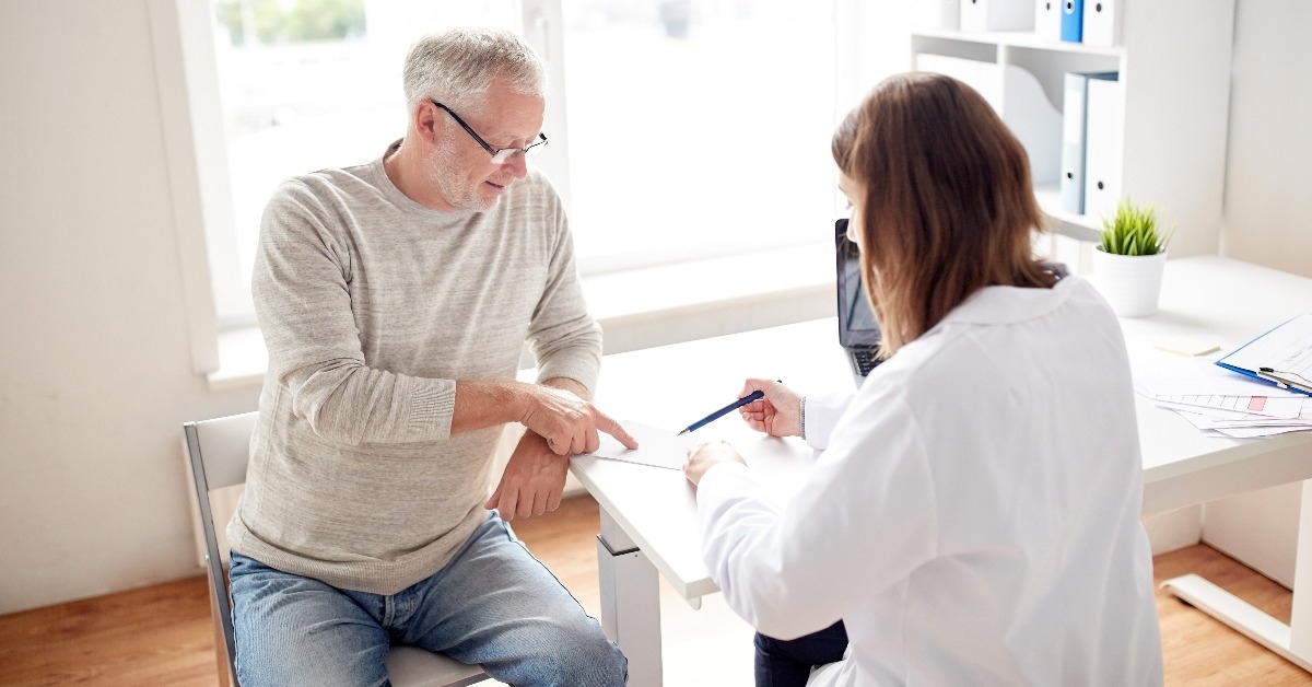 old man and doctor with prescription at hospital
