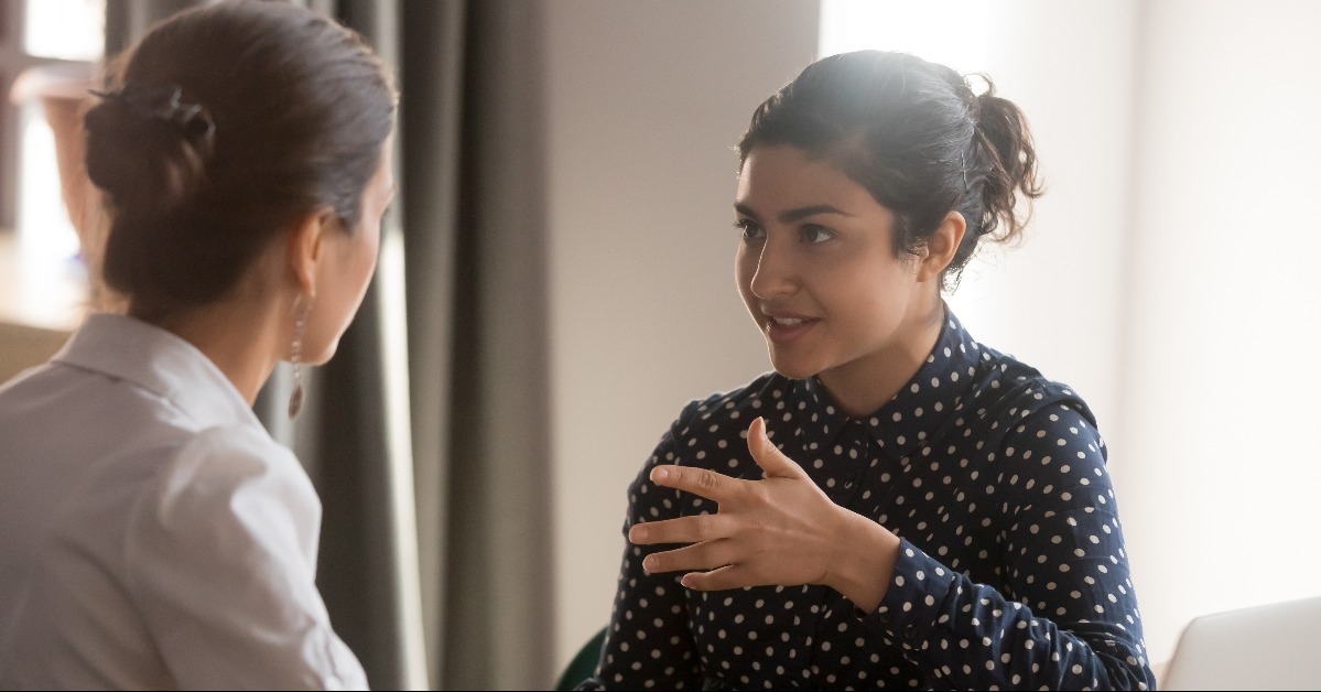 female mentor instructs an intern