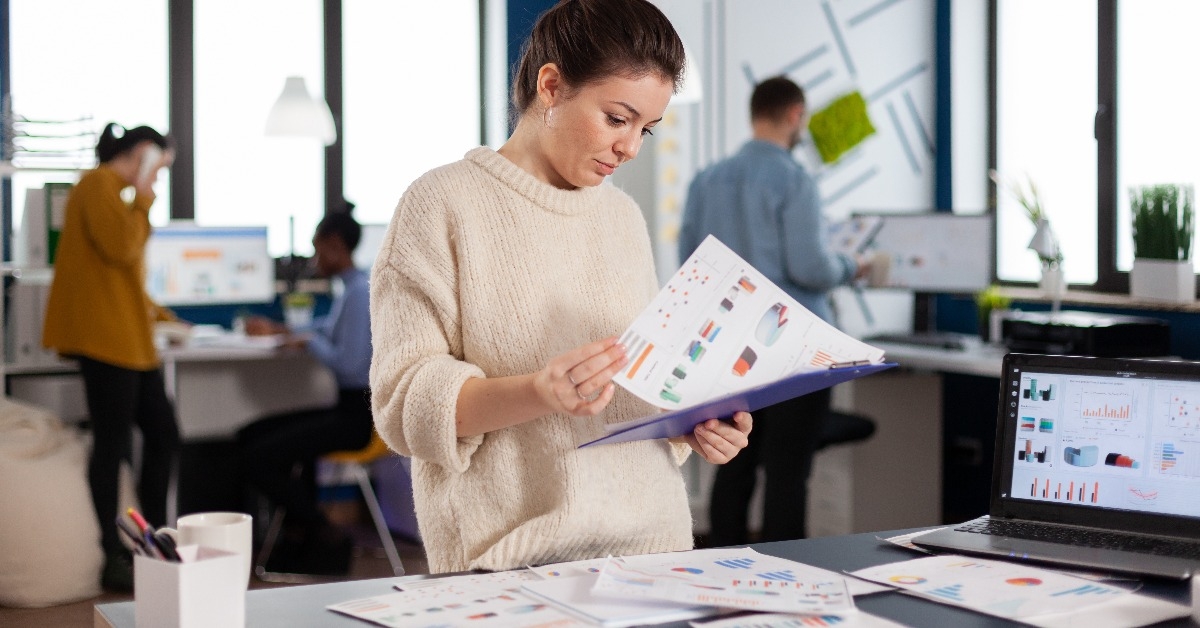 businesswoman working at her desk in the office checking and analysing report