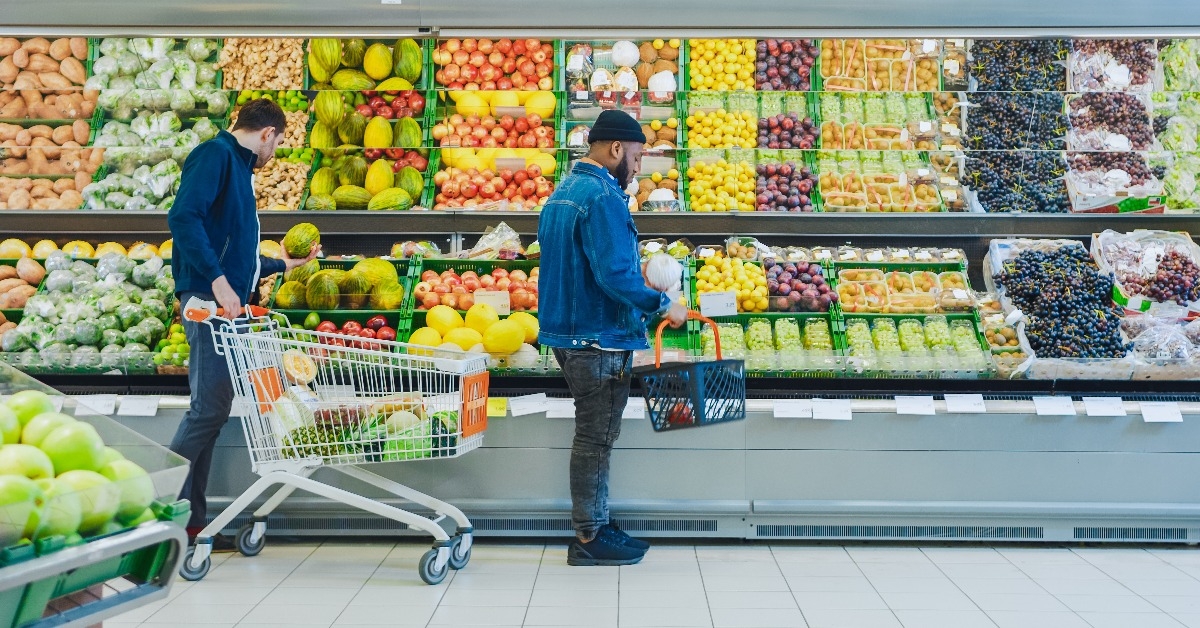 guy with basket shopping for organic fruits and vegetables