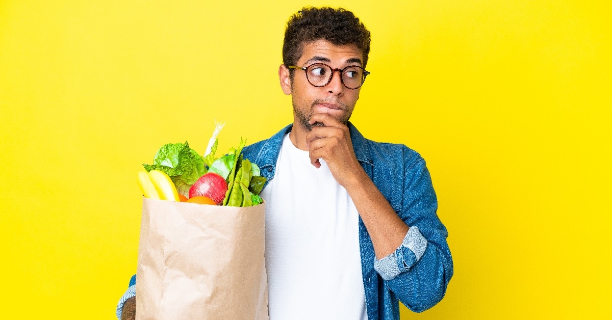 man holding a grocery shopping bag