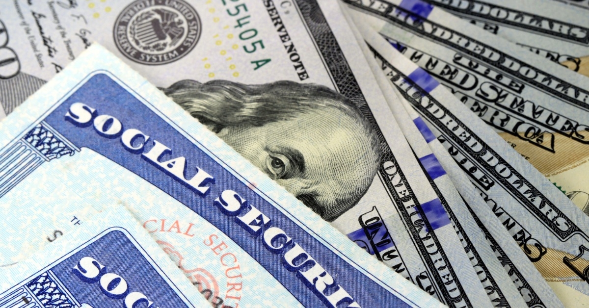 one hundred dollar bills with social security cards