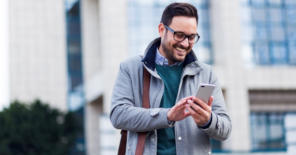 man using smartphone in street