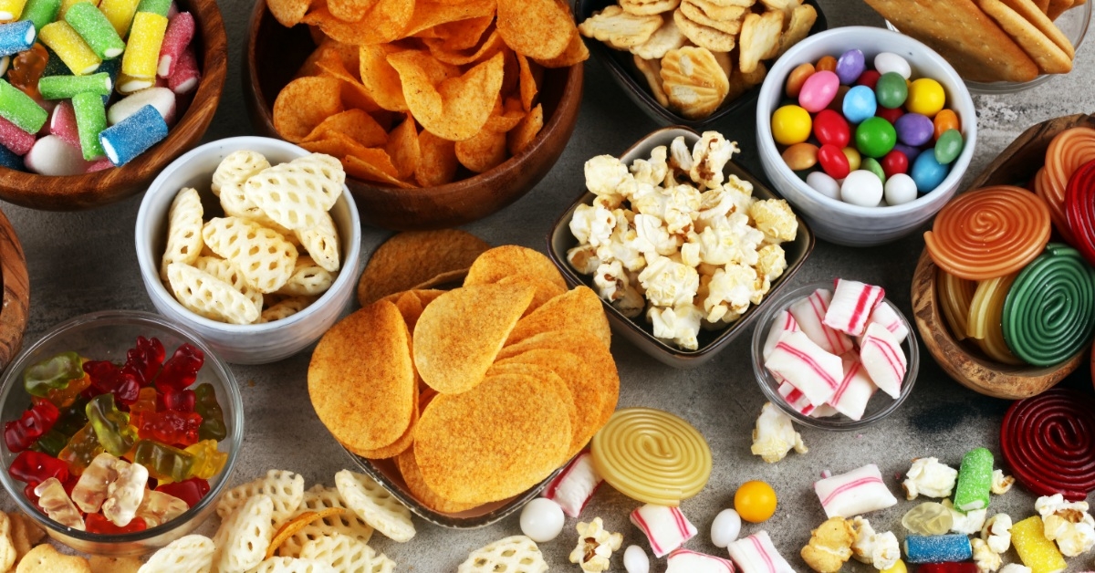 candies and pretzels in bowls on table
