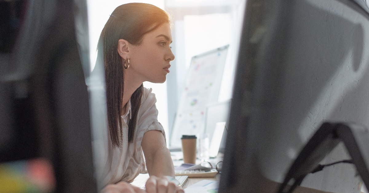 information security analyst testing software for computer systems in office