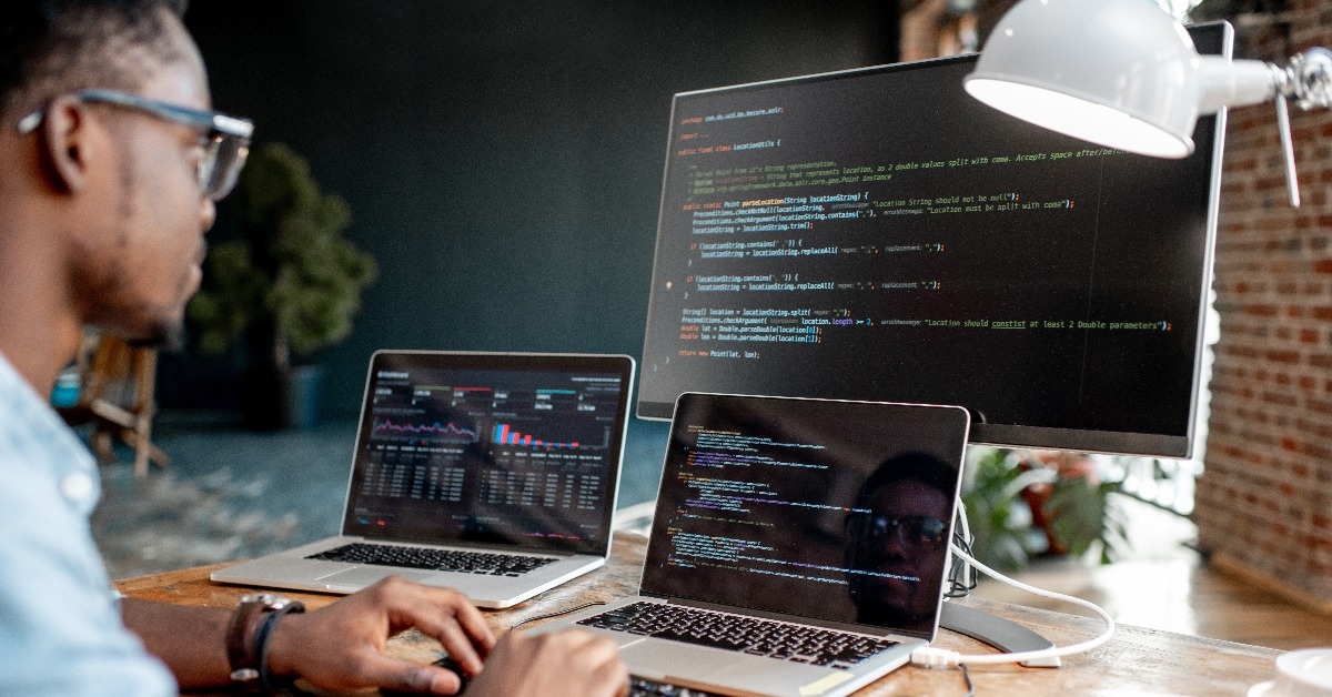 male programmer writing program code