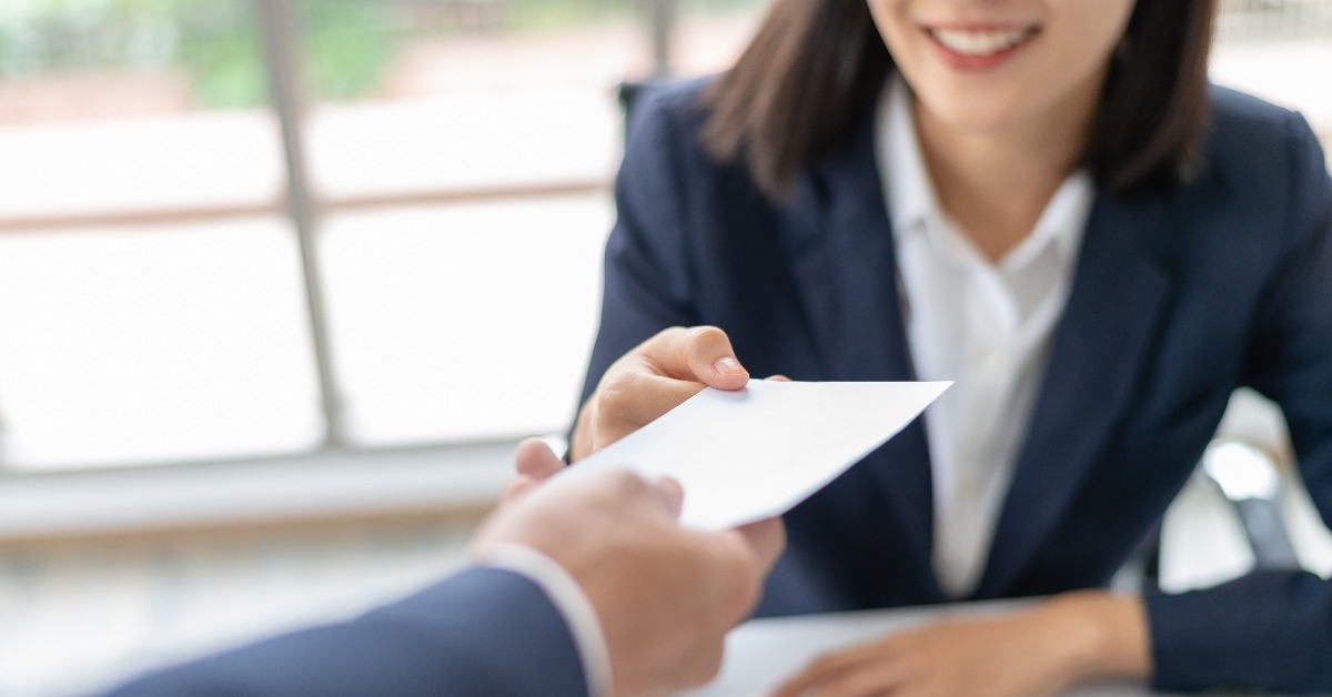 woman receiving salary from manager