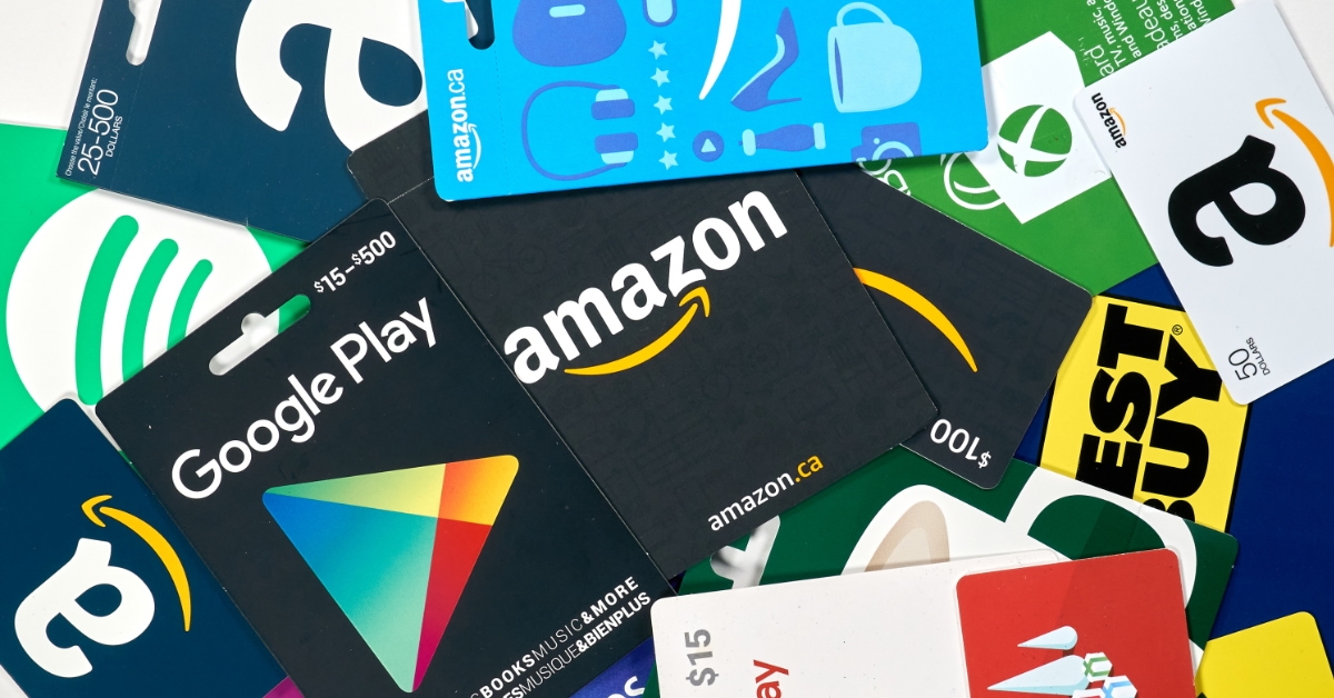 google play, apple store and amazon gift cards on a table