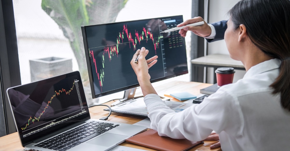 checking stock market graphs on monitor