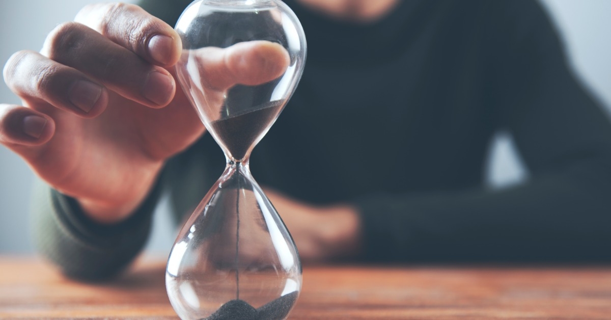 man holding hour glass 