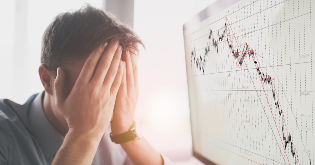young man stressing at charts on monitor