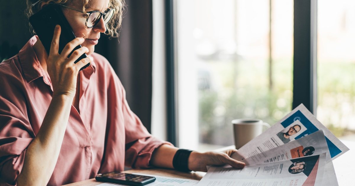 manager looking at many different cv resume