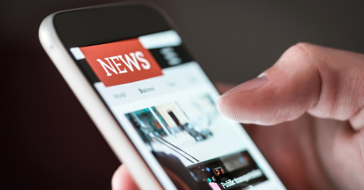 person reading news on smartphone