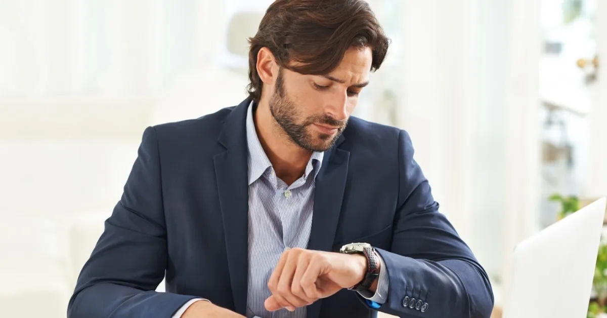 businessman watching time on wrist watch