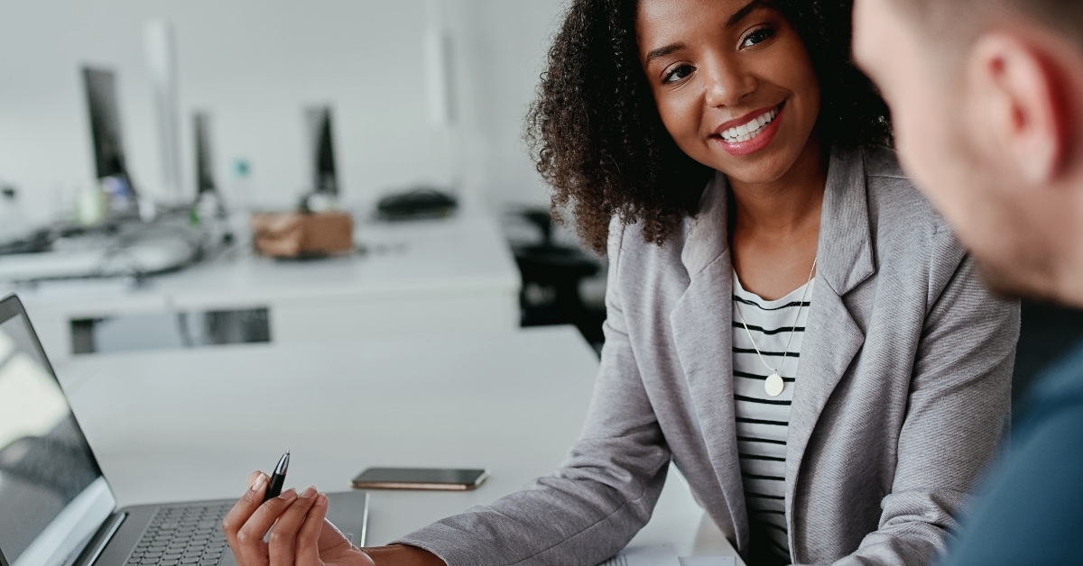 female leader talking with male coworker