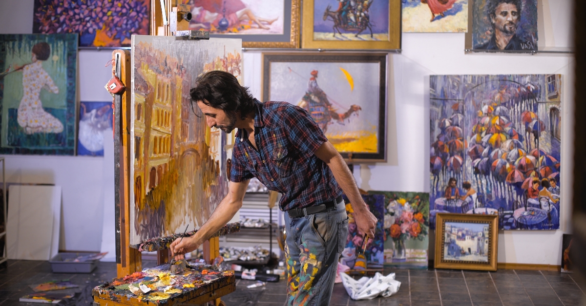professional artist paints with oil