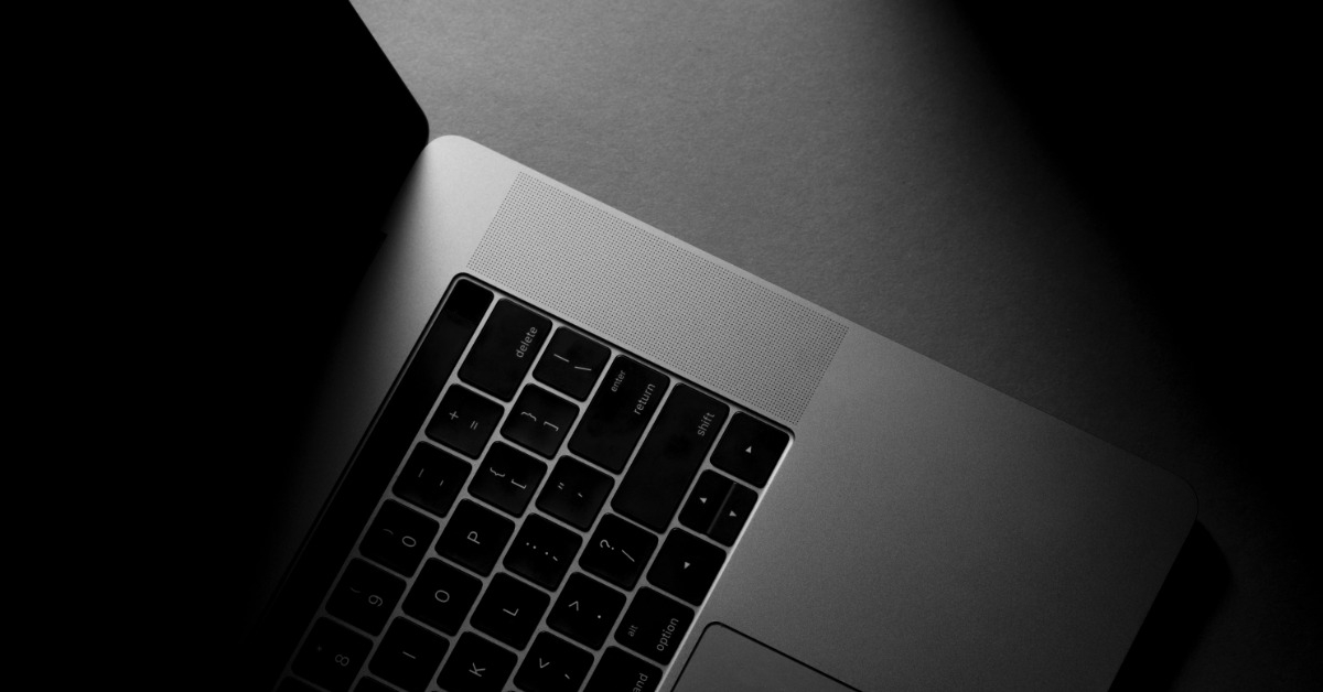 silver macbook on table