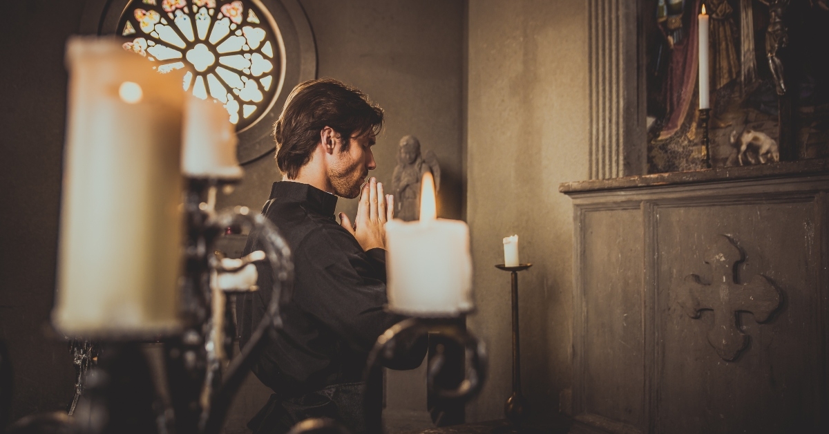 priest reading and praying in the church