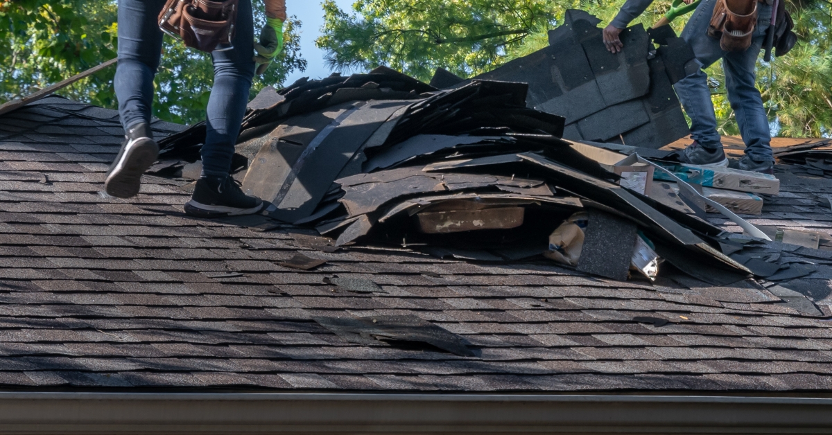 roofers removing old material from a house